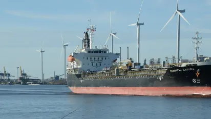 Chemical-oil products tanker passing by wind turbines