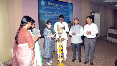 A group of people standing around a ceremonial centrepiece.