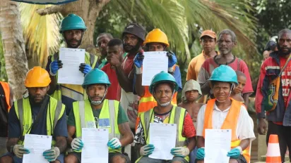 Group of workers (men) holding their certificates