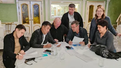Group of seven people gathered around a table