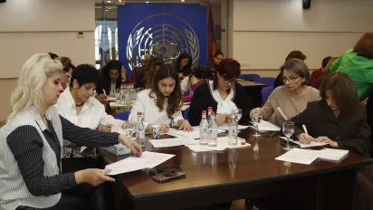 Group of people seated around a conference table engaged in a discussion