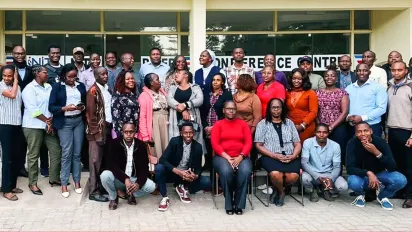 A large group of stakeholders poses for a photo outside a conference facility in Kenya after a forum to validate new occupational curricula for the tourism and fodder sectors.