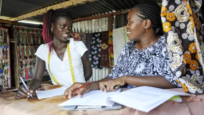 Two women answering a questionnaire in a small shop. 