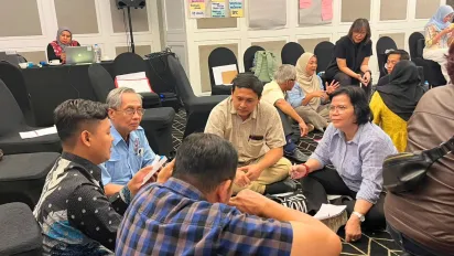 A group of people sitting on the floor 