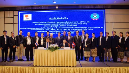 Representatives of the Lao Federation of Trade Unions (LFTU) and the International Trade Union Confederation–Thailand Council (ITUC-TC) sign a memorandum of understanding.