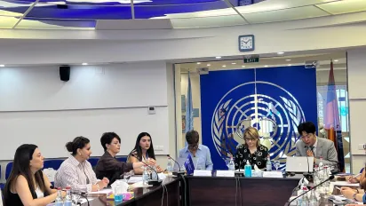 Participants seated around a conference table during a meeting