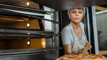 Woman baking a pizza