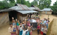 Villagers gather around a solar panel.