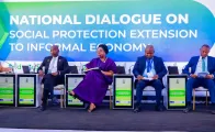 A group of high-level stakeholders seated on stage at the National Dialogue event
