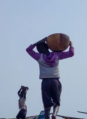Child carries a bucket in a mine