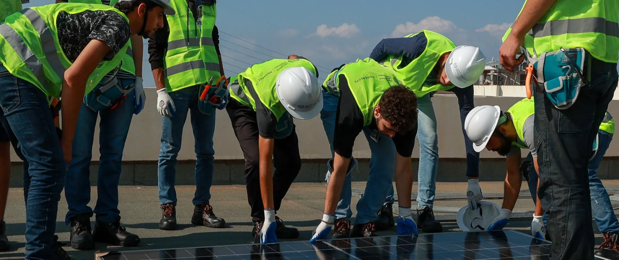 a group of workers lifting a panel for solar system