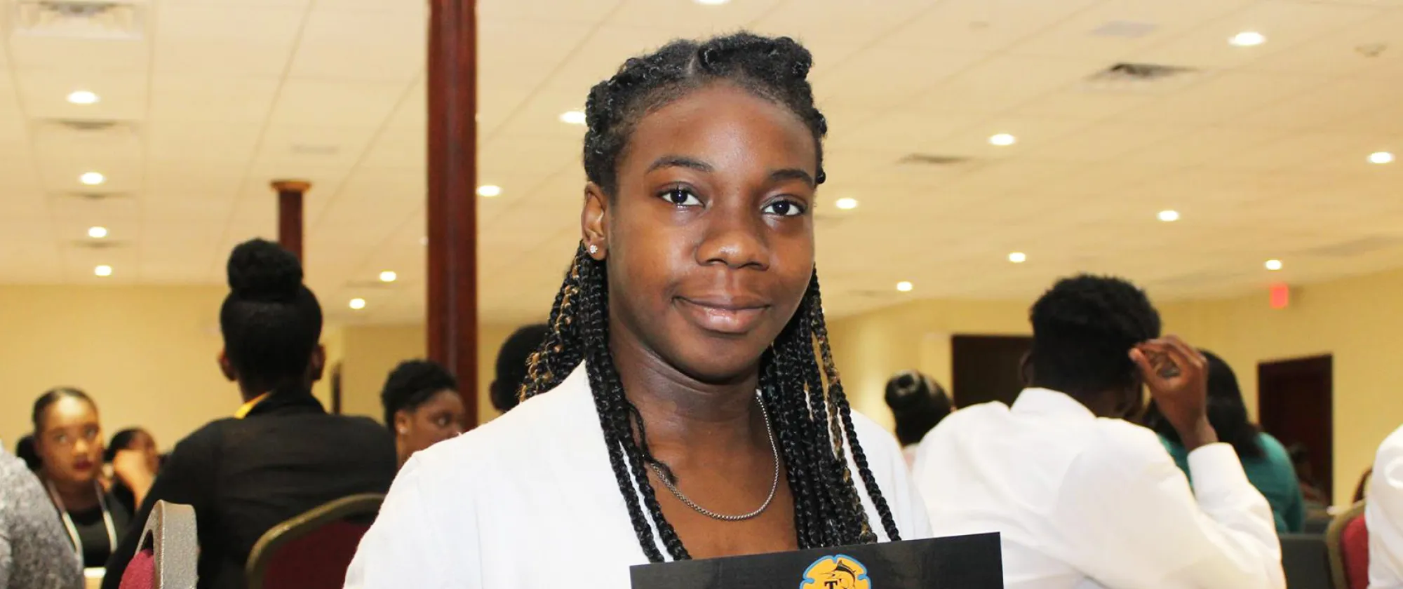 A young female apprentice holding a sign