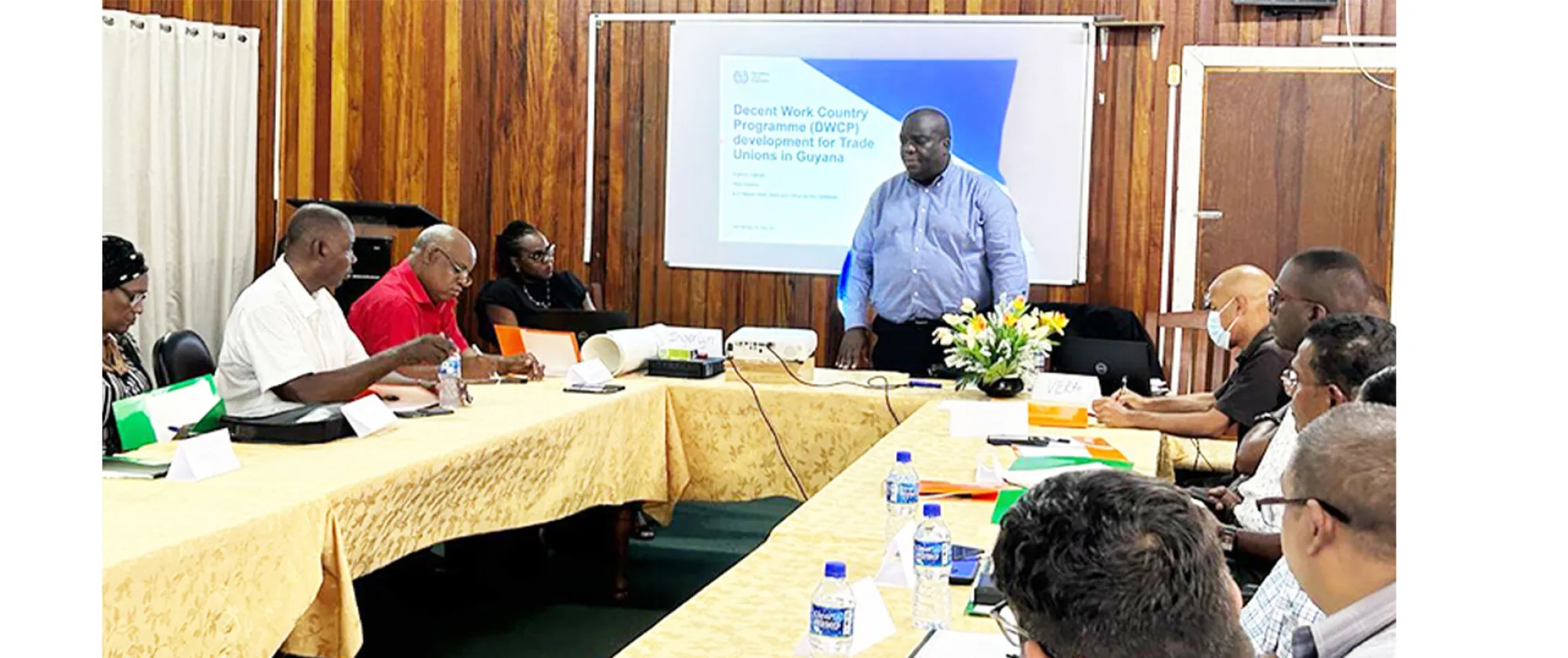 A man addressing a room of persons