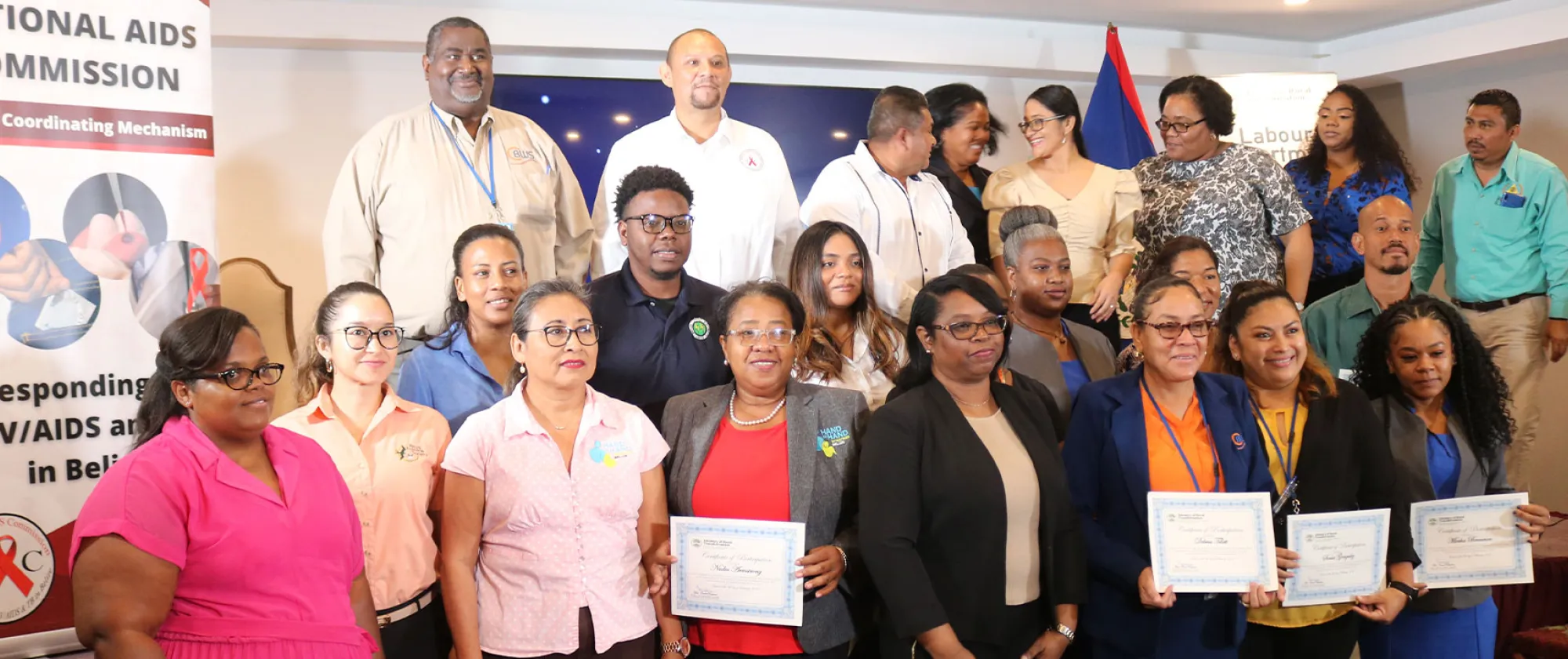Group photo of people standing holding certificates