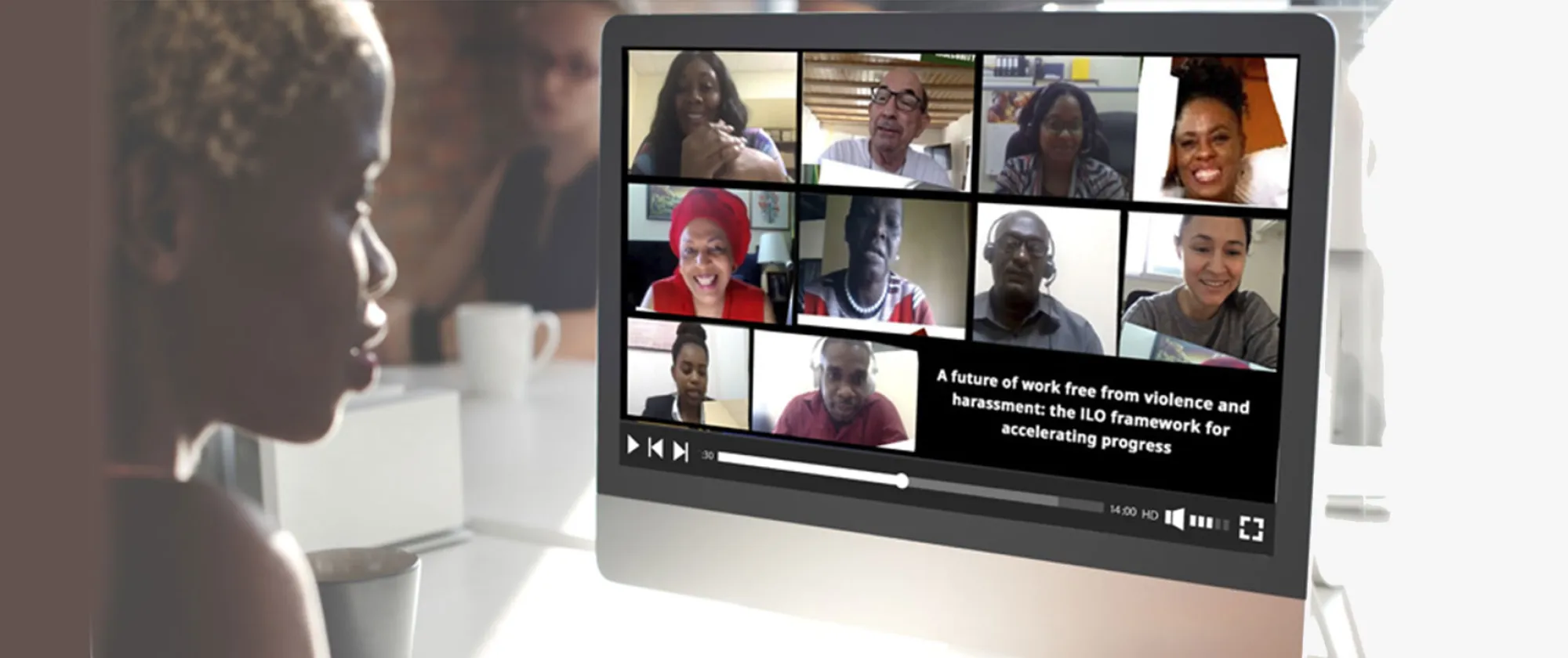 A woman watching a virtual seminar with participants on the screen