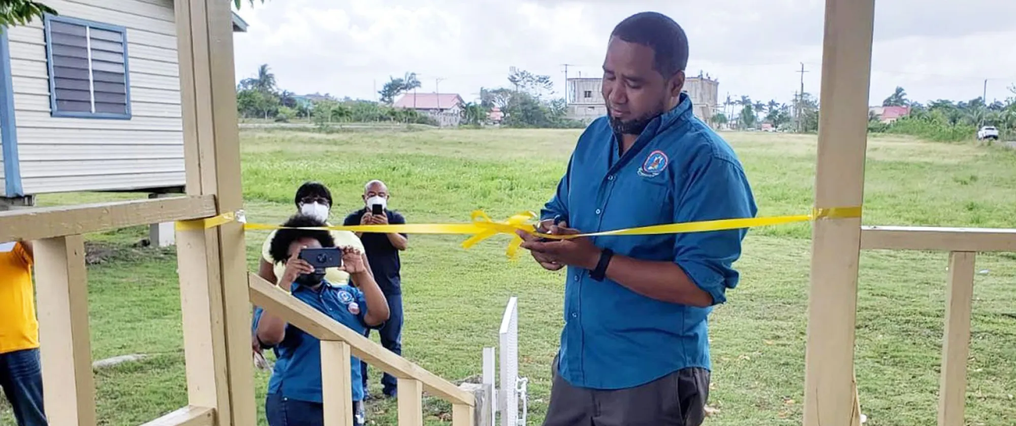 Mr. Luke Martinez, President, National Trade Union Congress of Belize performing a ceremonial ribbon cutting