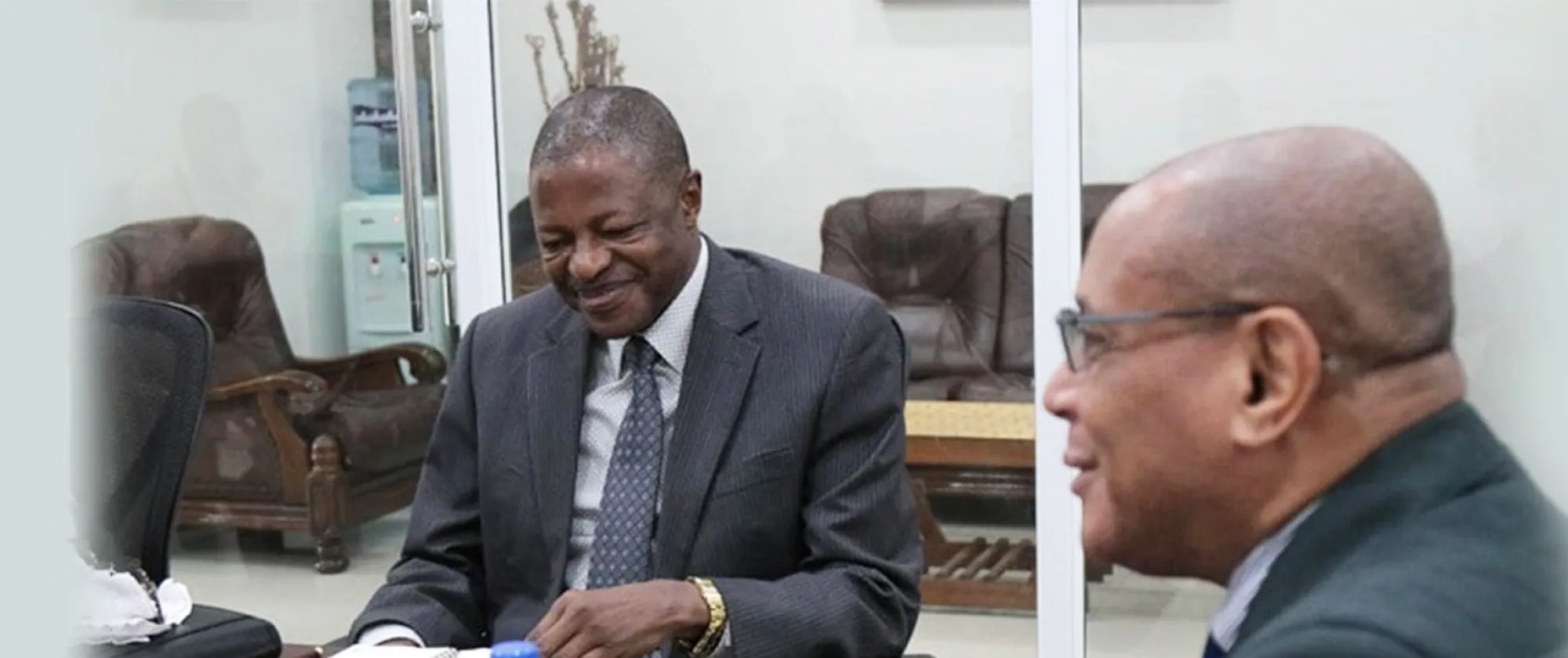 Two men sitting at a table in discussion