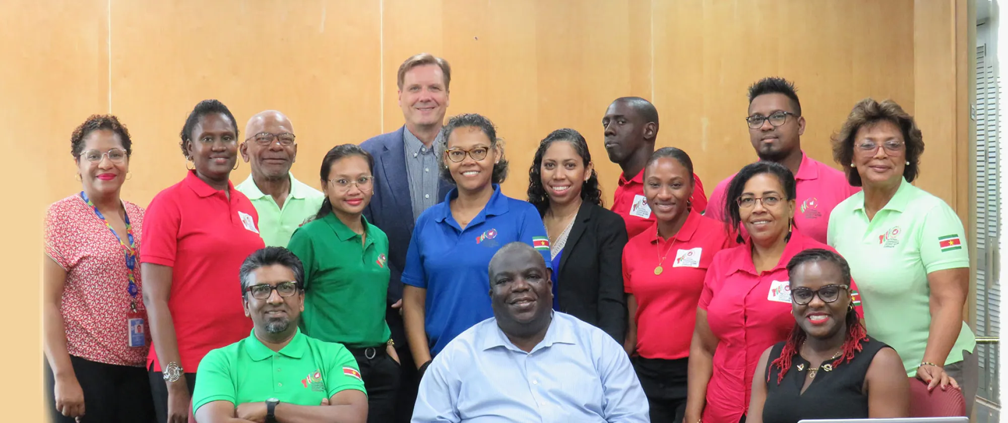 A group of people standing and smiling for a photo