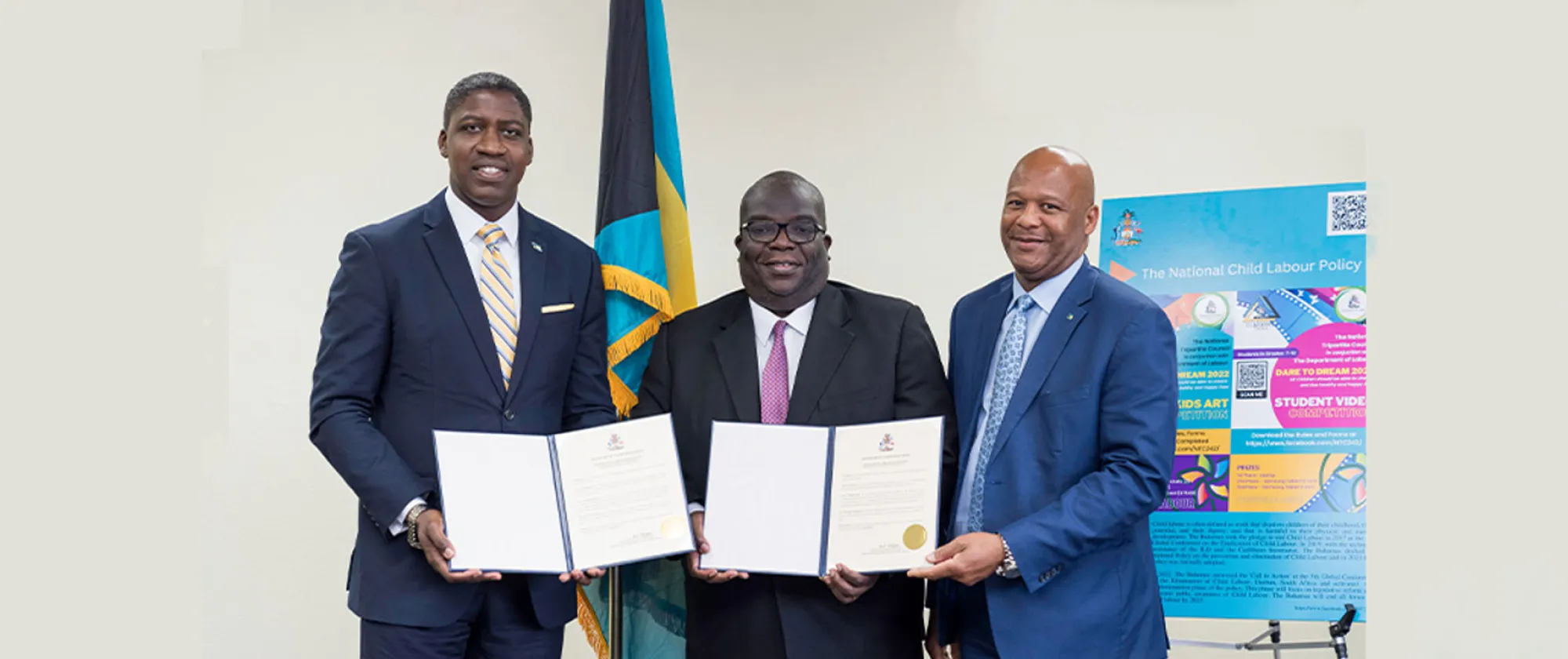 Three meeting standing holding two documents