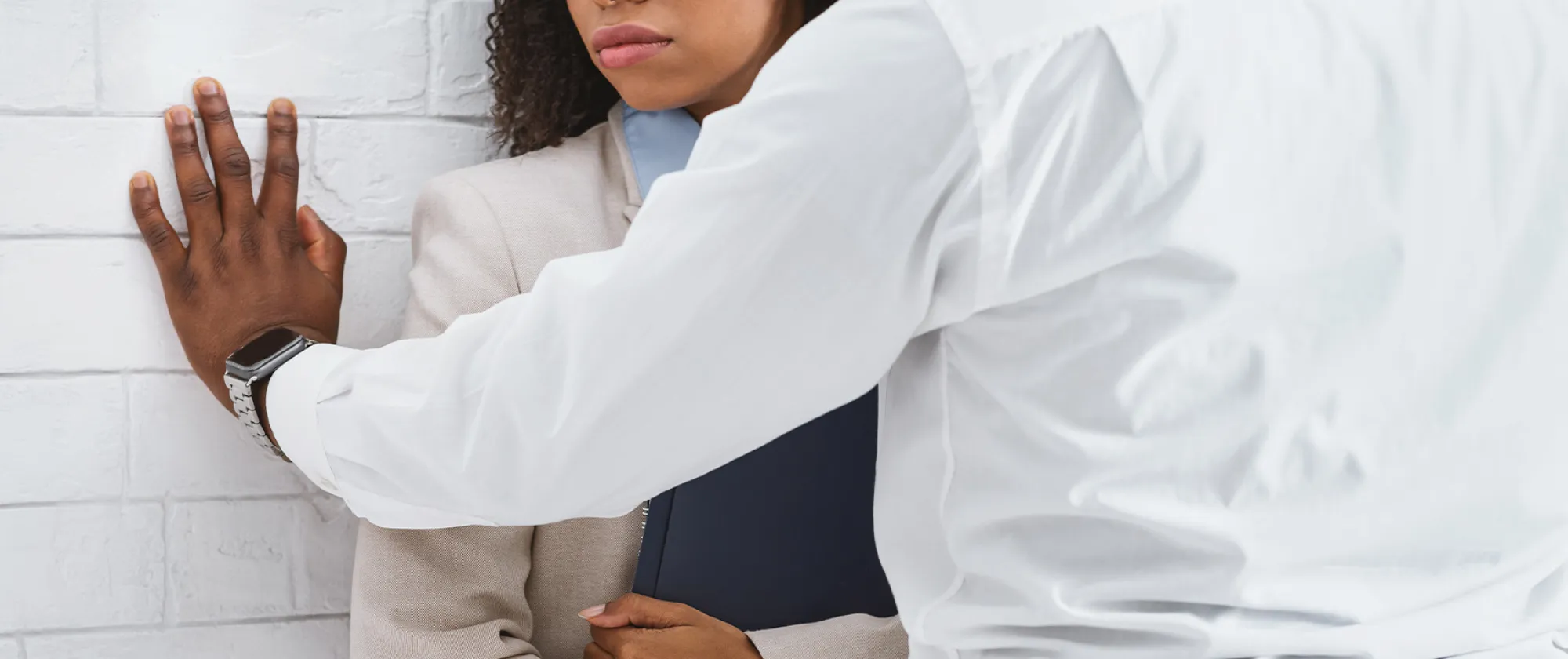 Closeup view of black guy making unwelcome sexual advances to his secretary in office