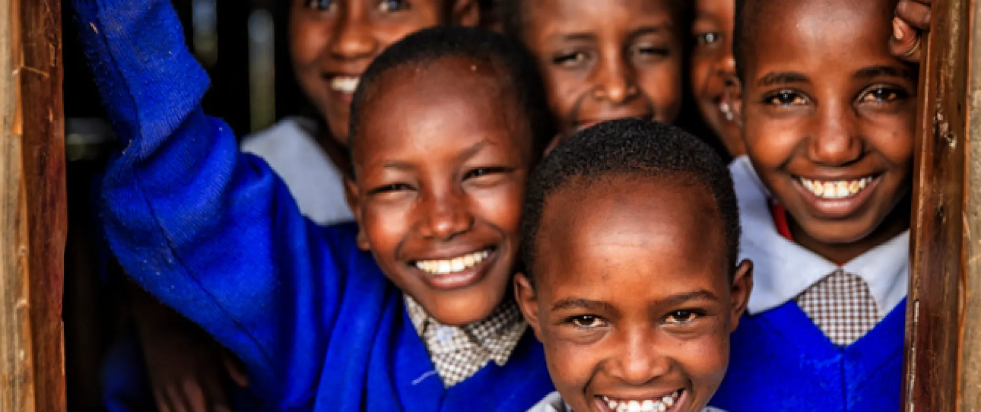 Children in school uniform smiling 