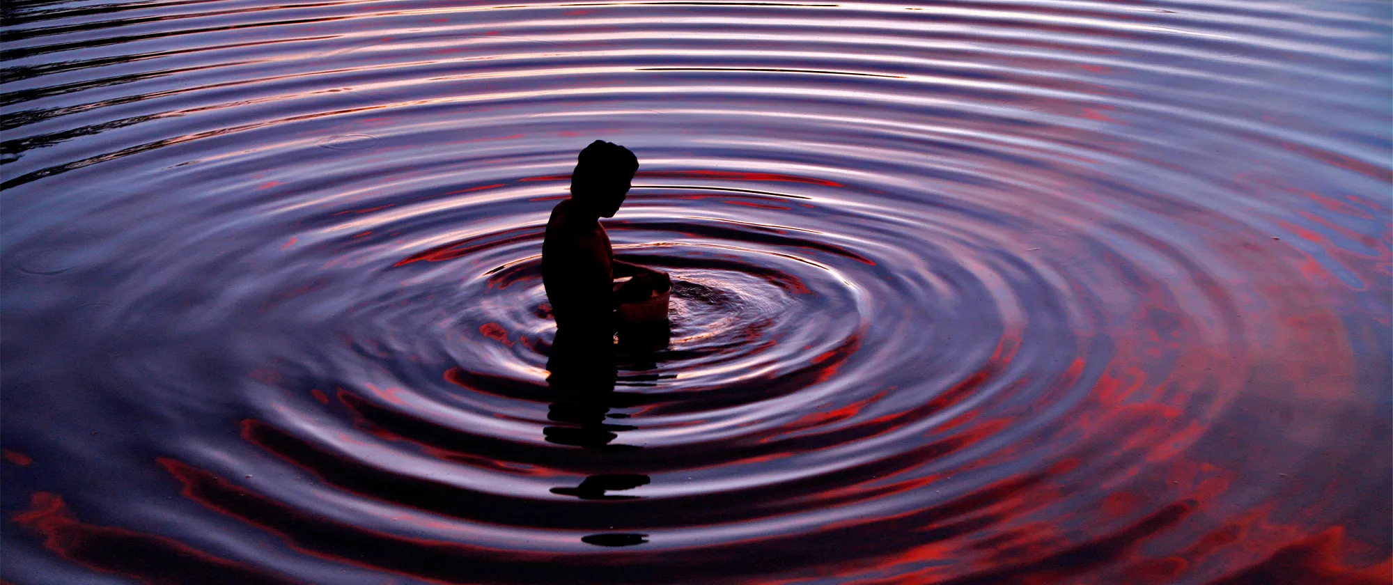 a fisher in water ripples