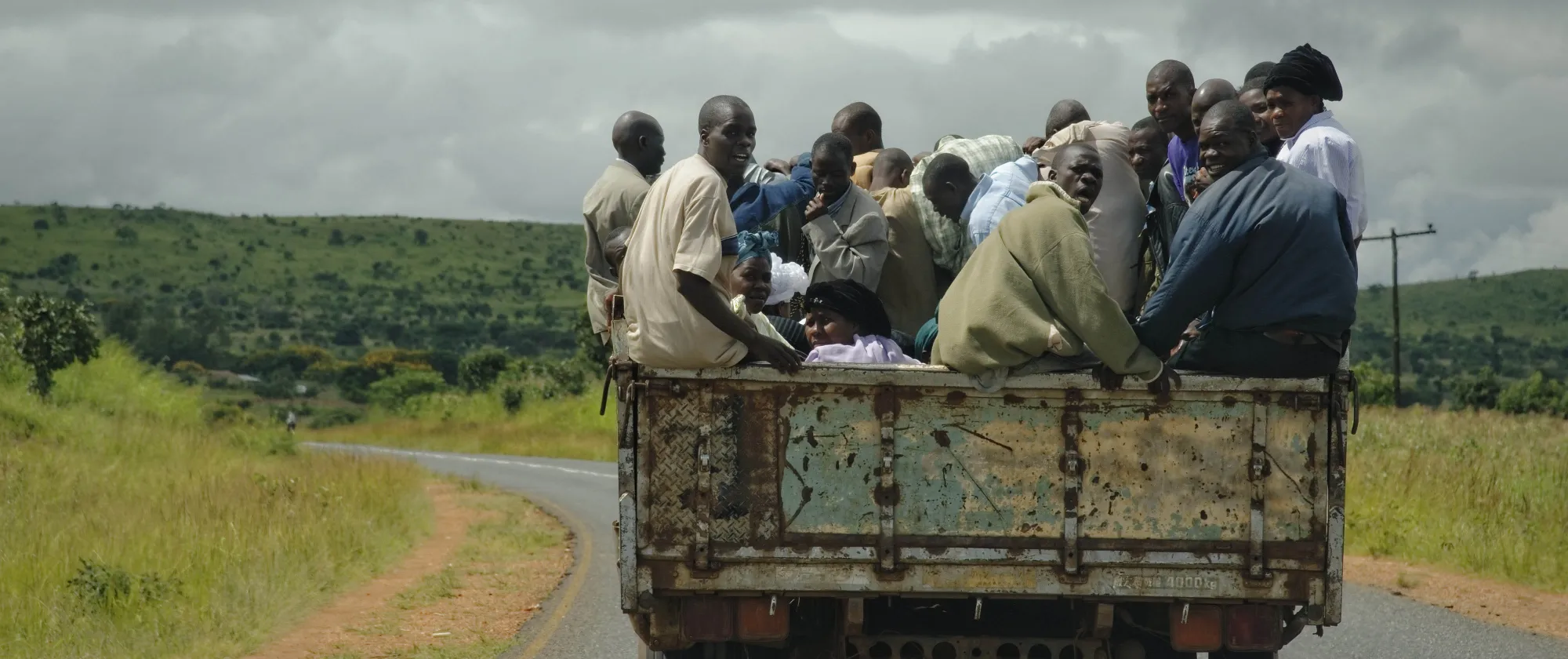Migrants riding over an open truck 