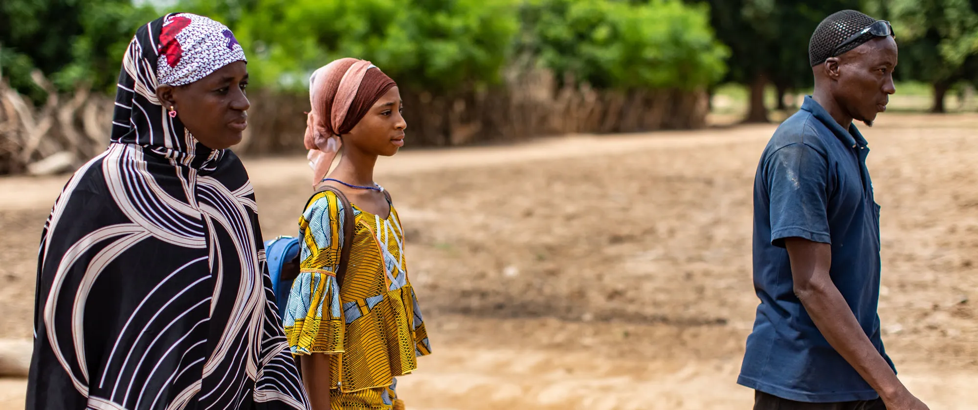 Girl beneficiary of the ACCEL Africa project in Mali walks with her parents
