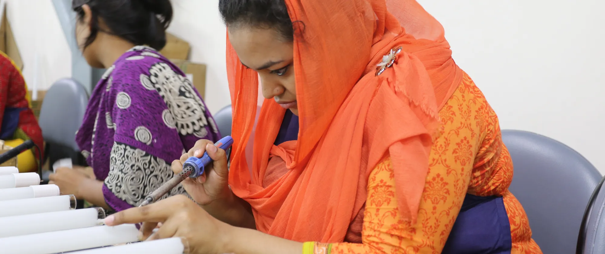 Afsana Akter working at Transcom group installing LED lights