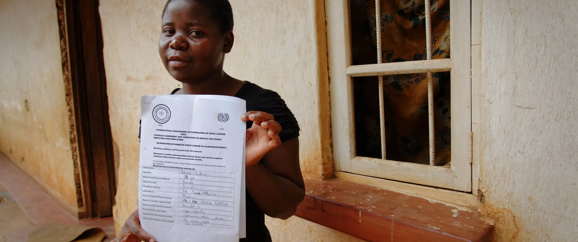 Young person holding a training certificate