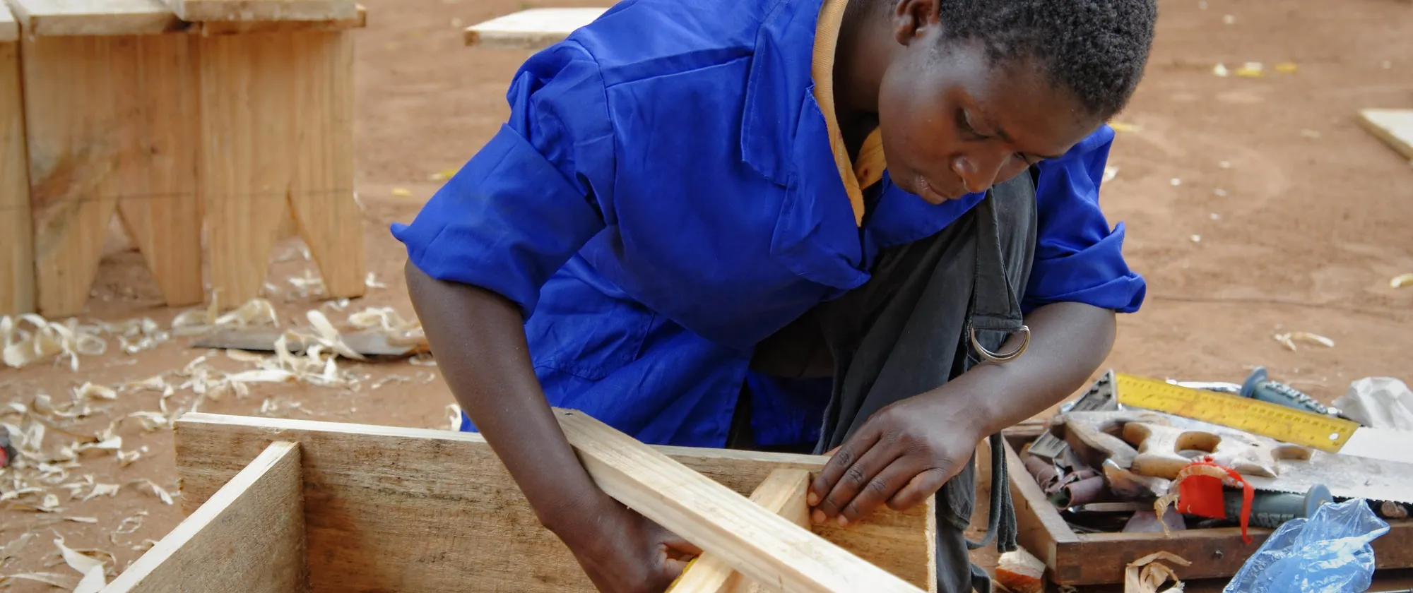 young person building a wooden bench