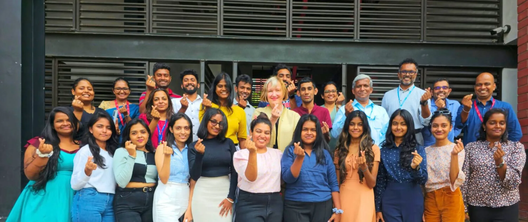 Group of young women and men pose for a picture