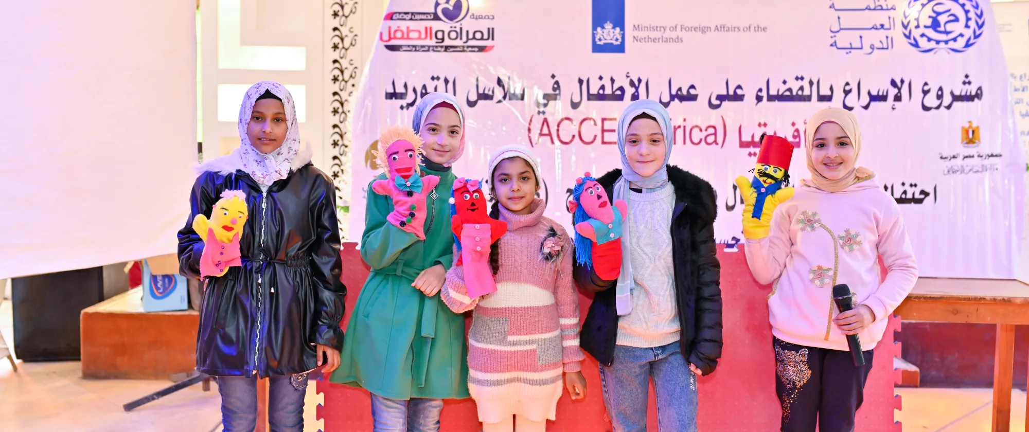 Children practice the SCREAM methodology and pose for the picture with toys