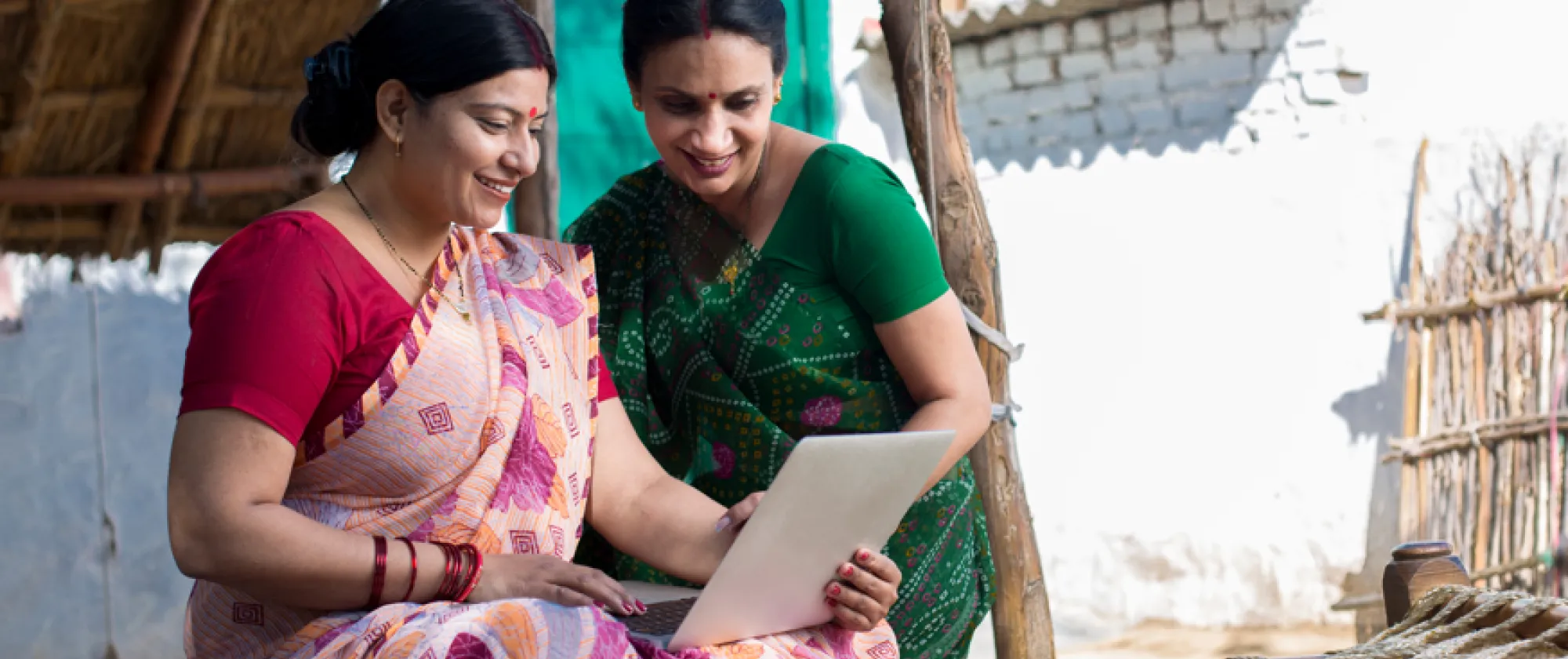 two women using a laptop