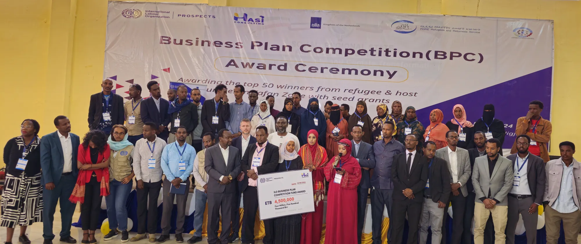Participants of a business plan competition posing for a group photo