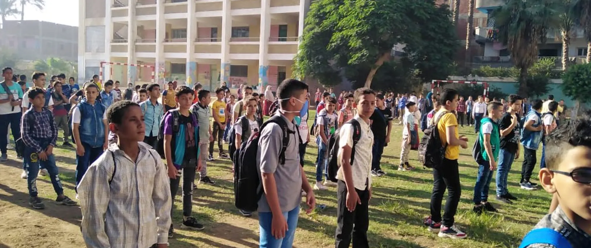 Boys line up in a green field in Egypt