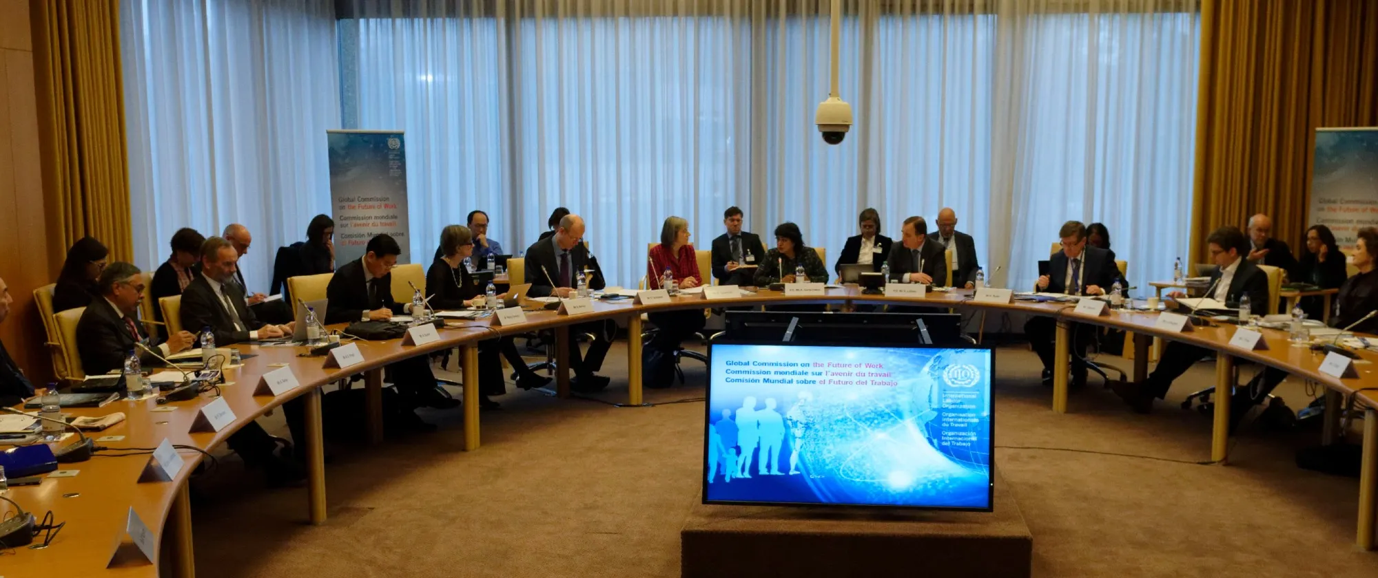 Business professionals seated at a table in a conference room, having a discussion.