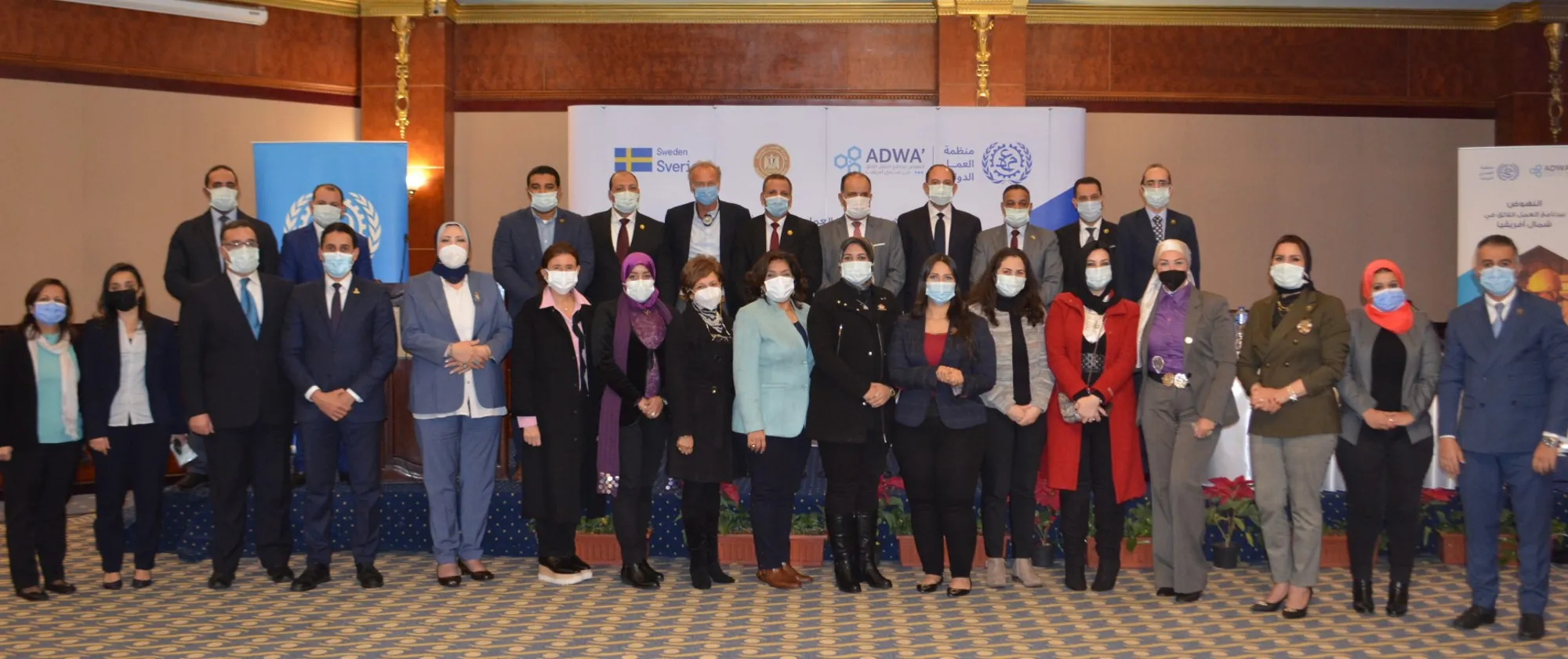 A group of people wearing face masks standing together.