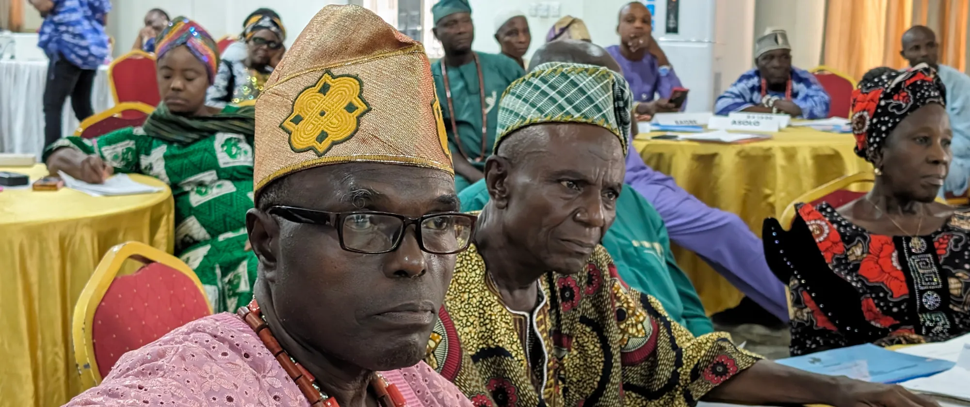 Members of Cocoa-producing community listening to feedback from State Government on their community action plan