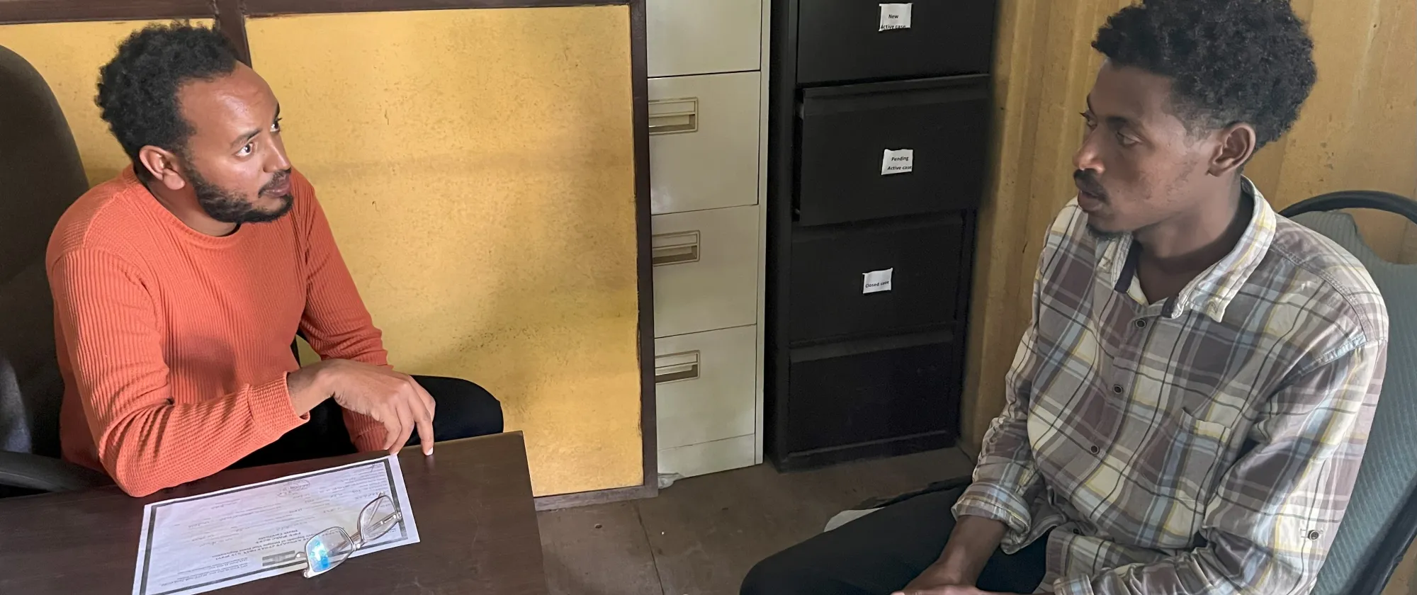 Legal advisor speking to a worker in an office