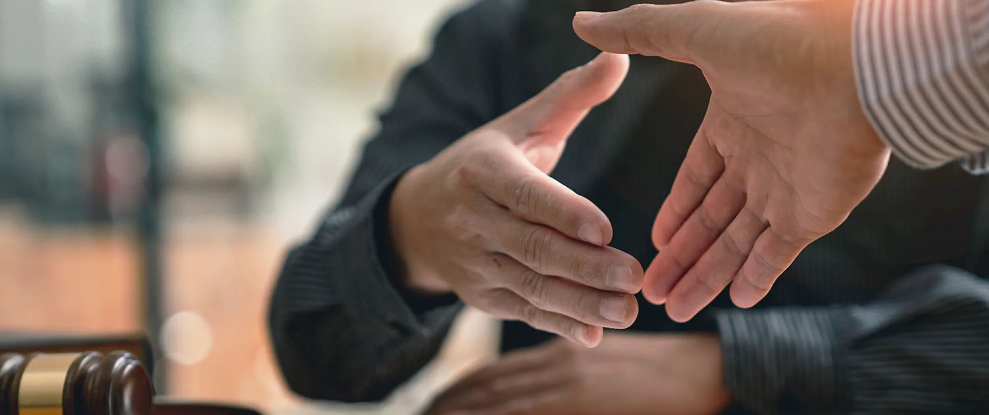 Persons shake hands in agreement