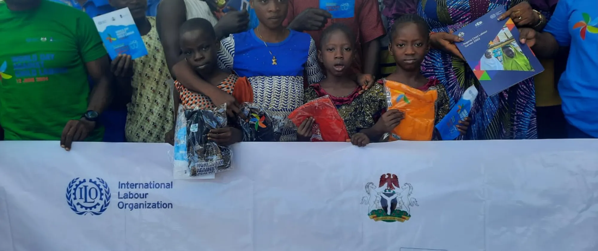 Children hold a banner of the world day against child labour