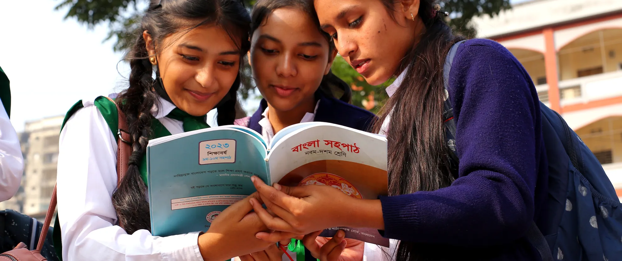 Bangladeshi students admire their new textbooks provided by the Government