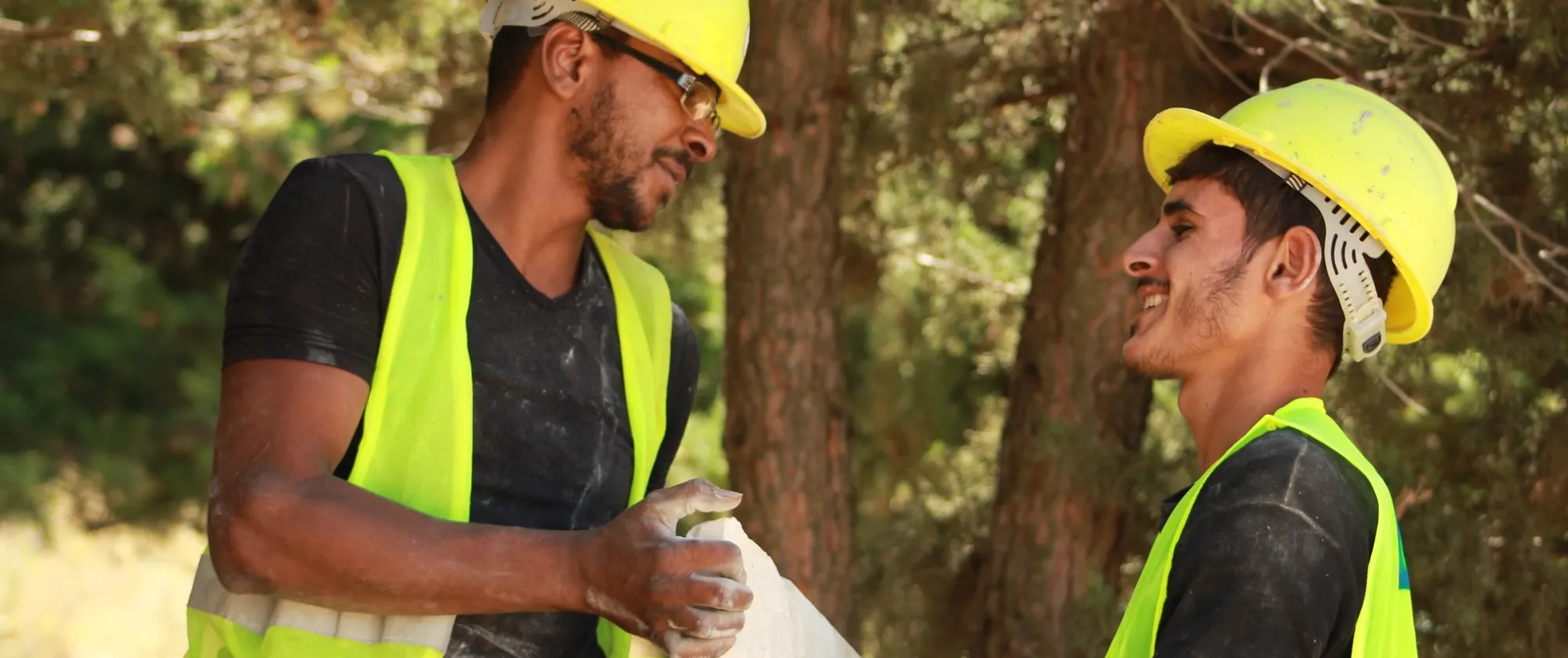 Two workers hold a slab of marble in Lebanon