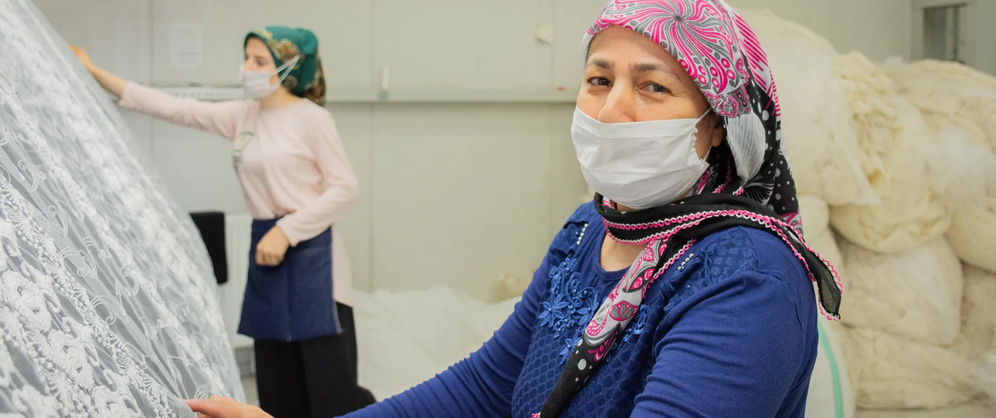 Two women weave textile at a workshop in Izmir, Turkiye