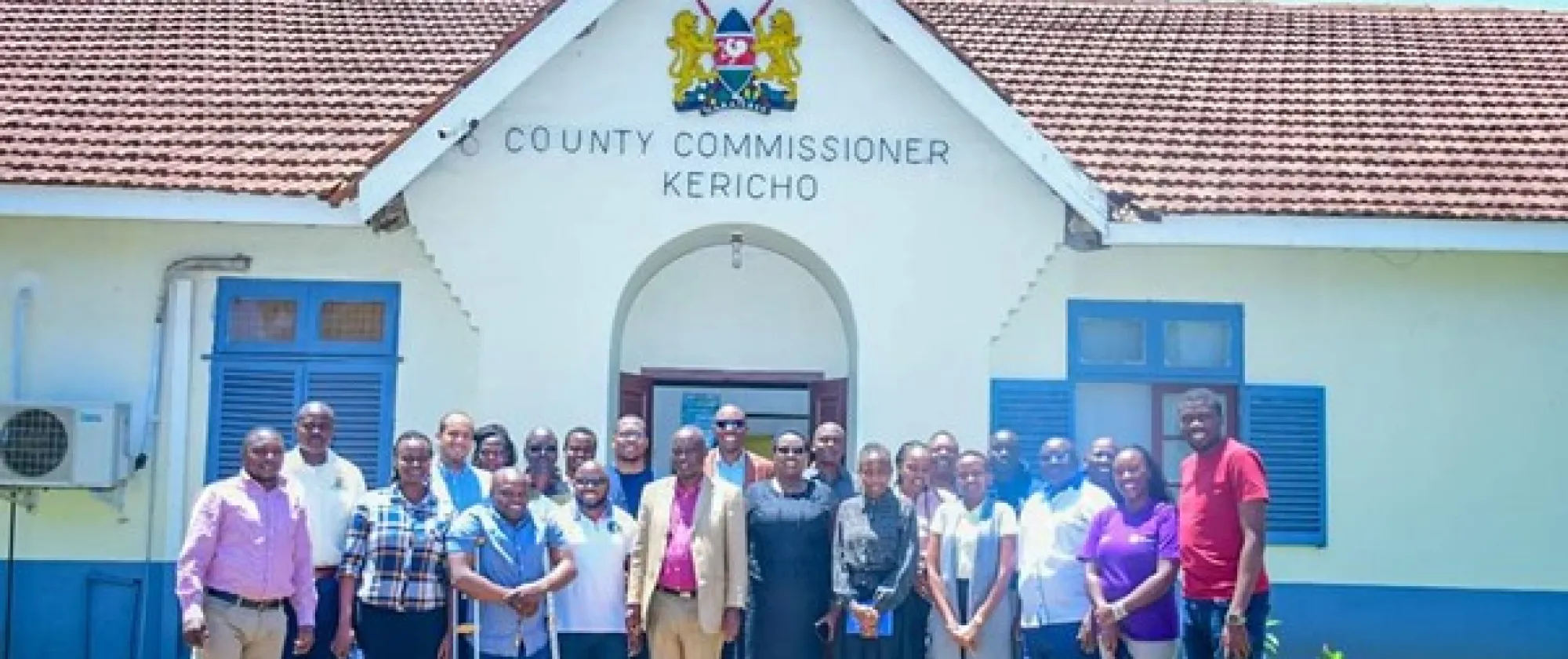 Participants pose in front of the county commissioner building in Kericho