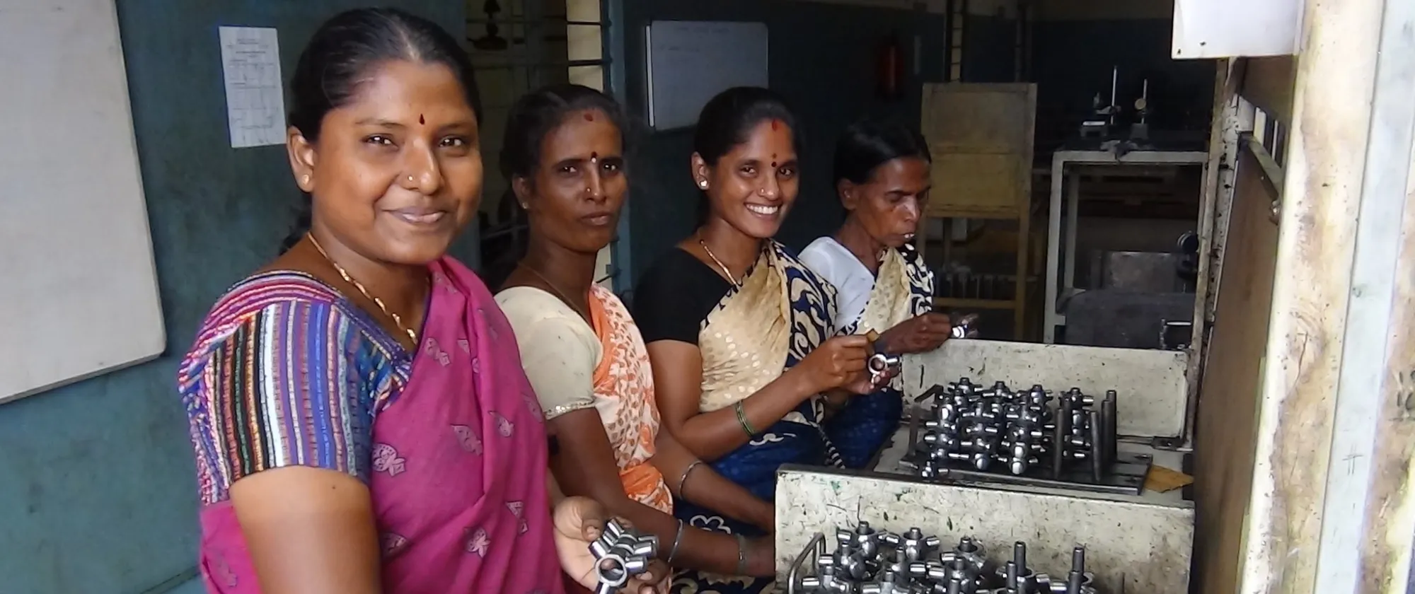 Female workers polishing auto parts. 