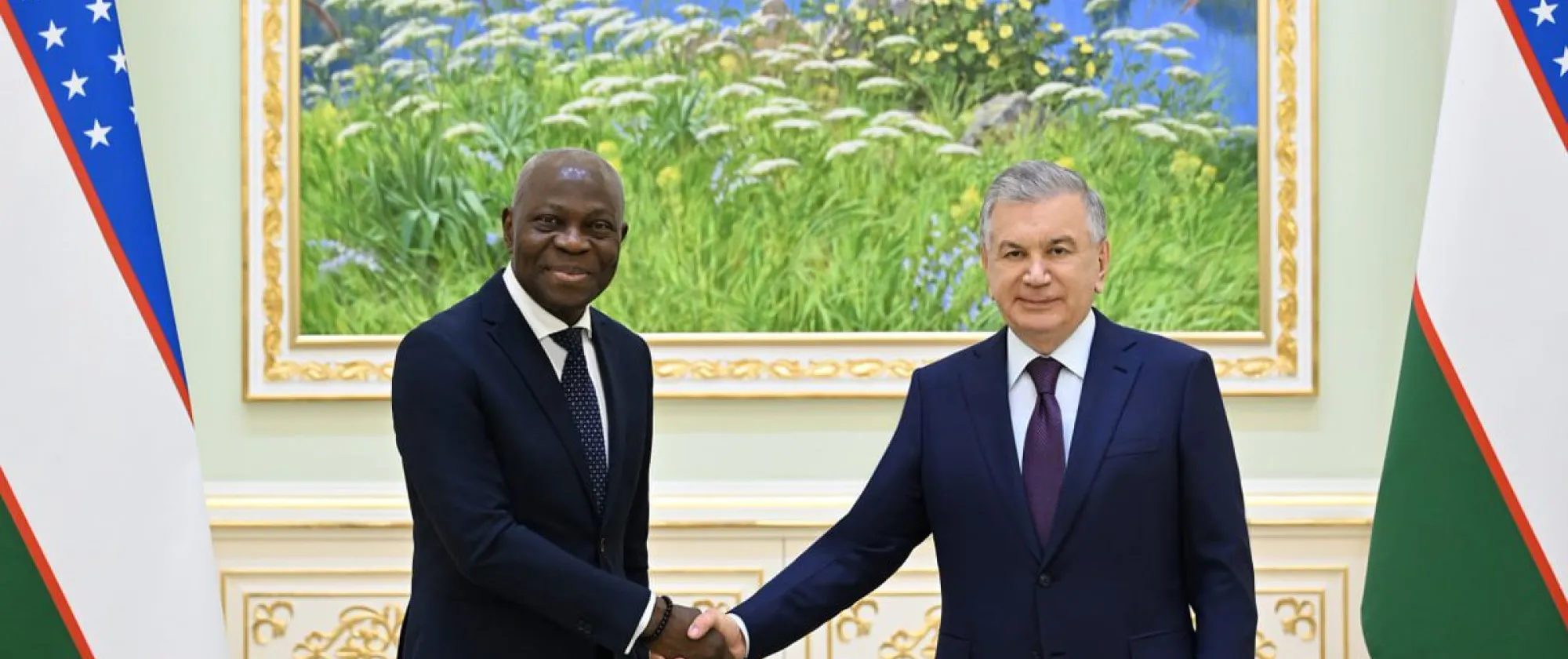 ILO Director-General Gilbert F. Houngbo (left) shakes hands with Uzbek President Shavkat Mirziyoyev (right)