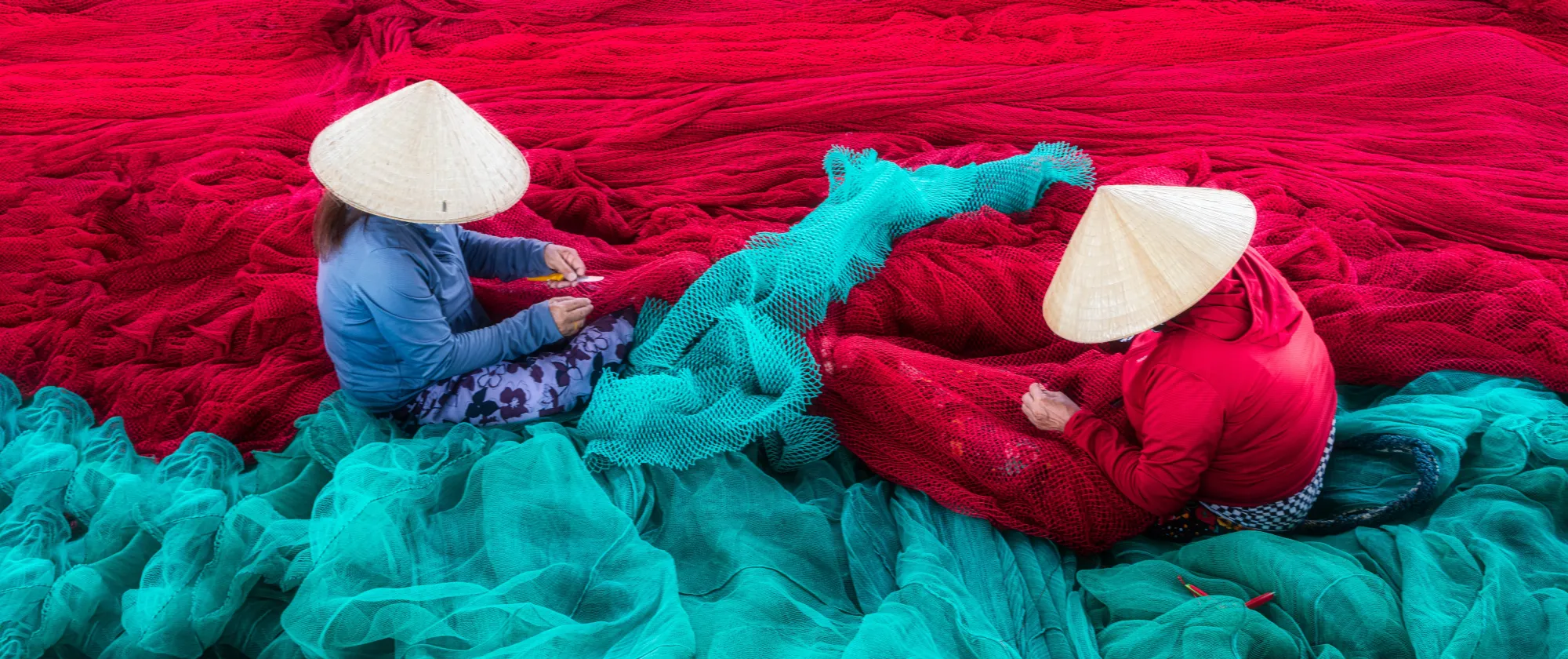 Two women sorting fishing nets in Viet Nam