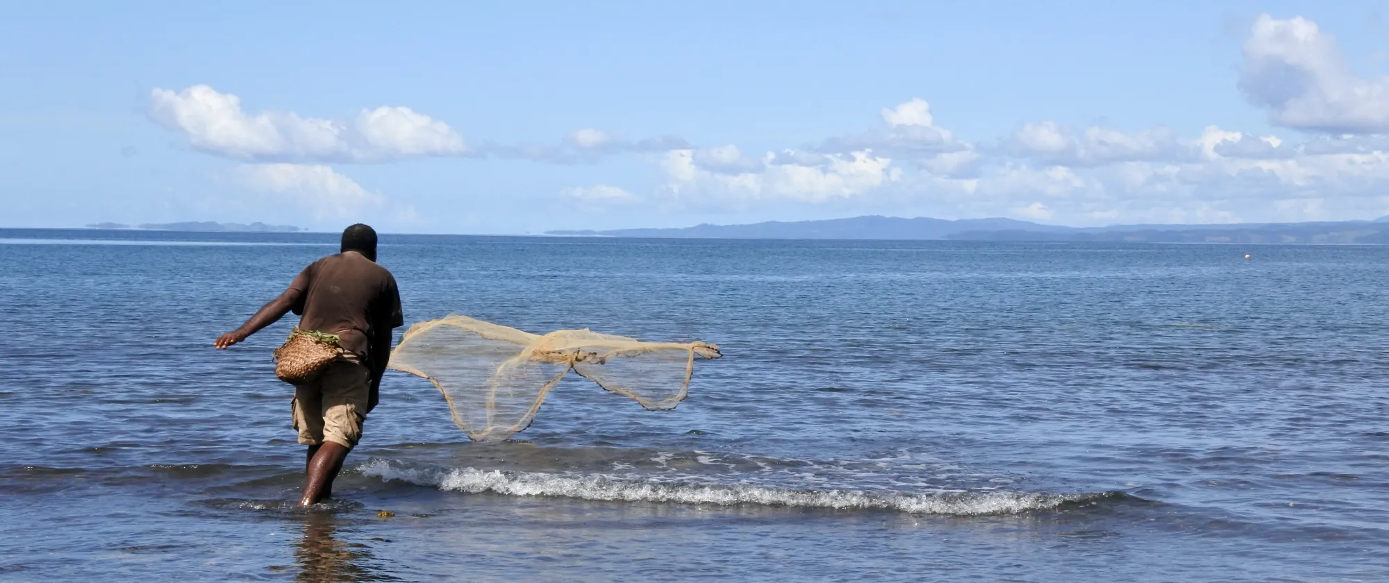 fisherman throwing his fishing net 
